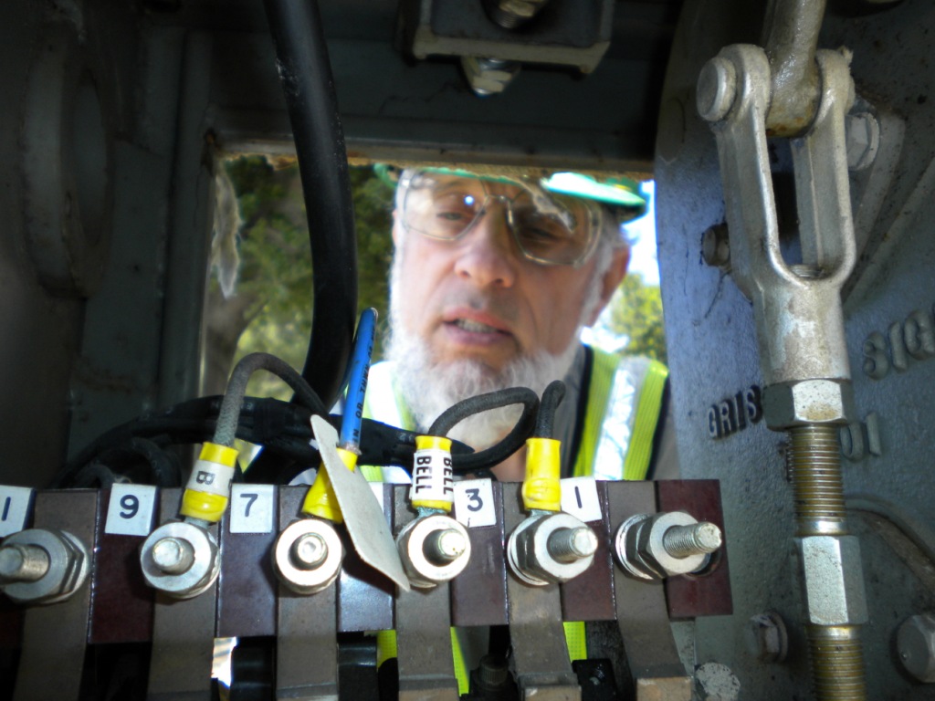 Dave checks the circuit controller at Kilkare crossing's north gate. " Now where did I drop that washer?"